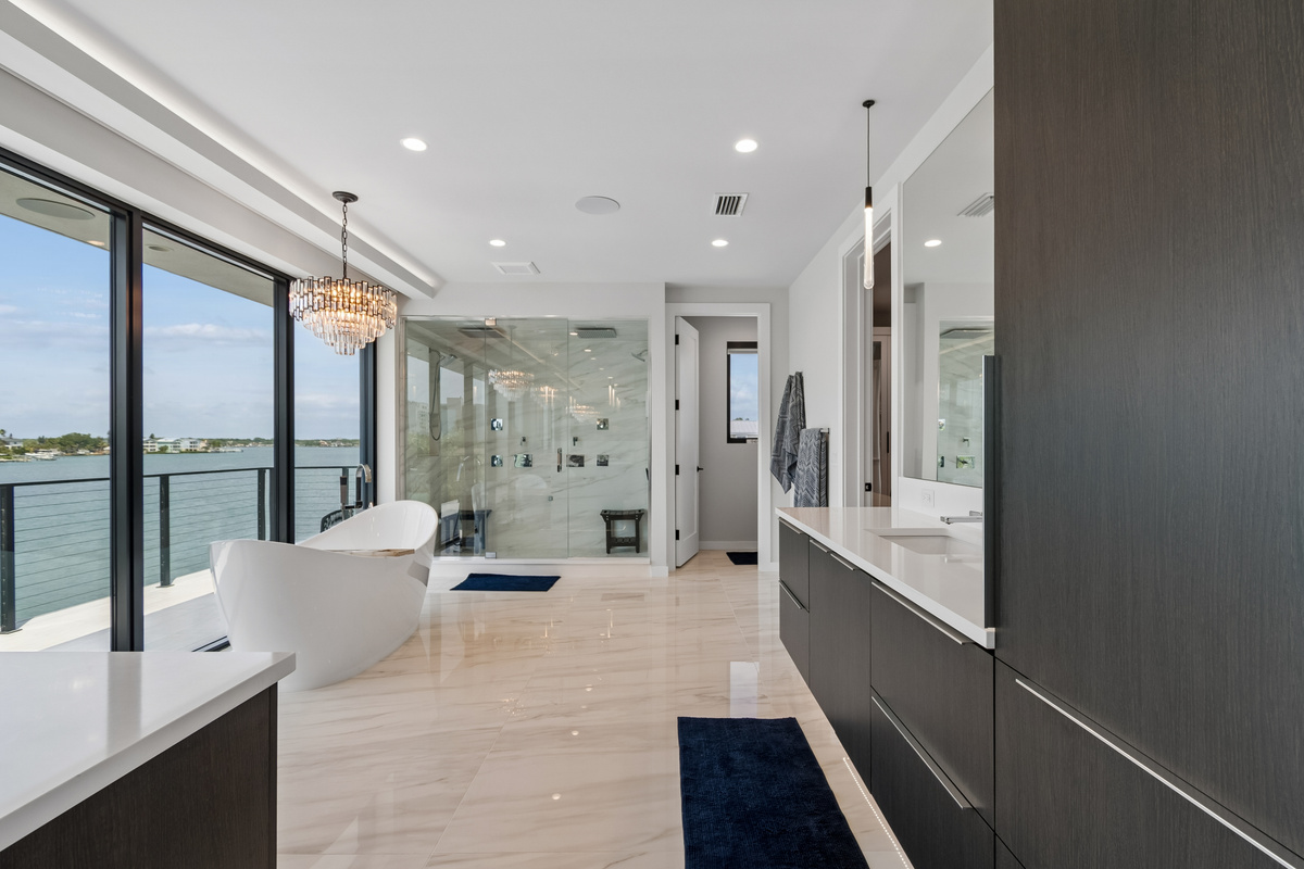 Dual vanities while looking out onto the water make this Primary bathroom ensuite a sanctuary of its own