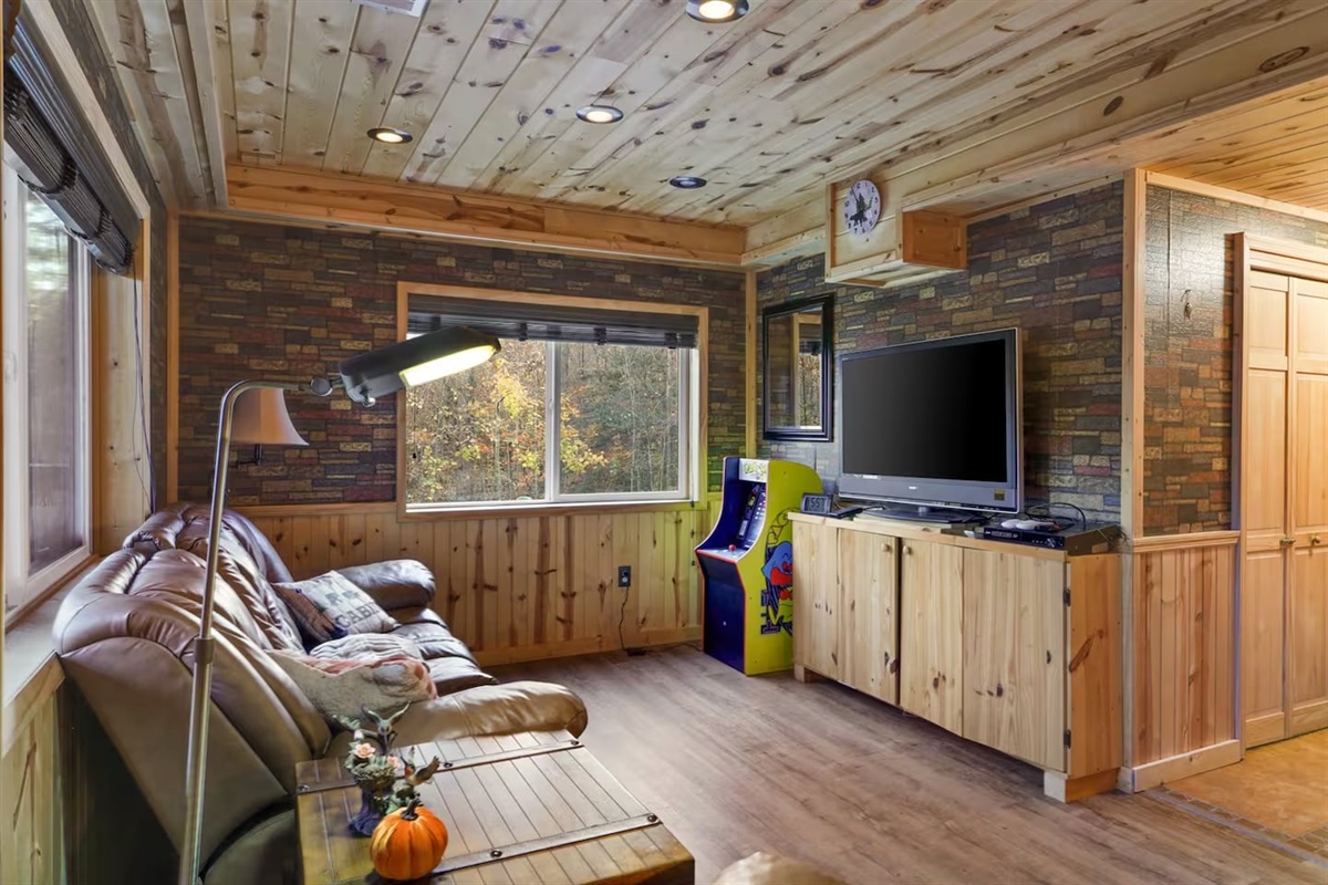 TV with relaxing couch in main games/recreation room