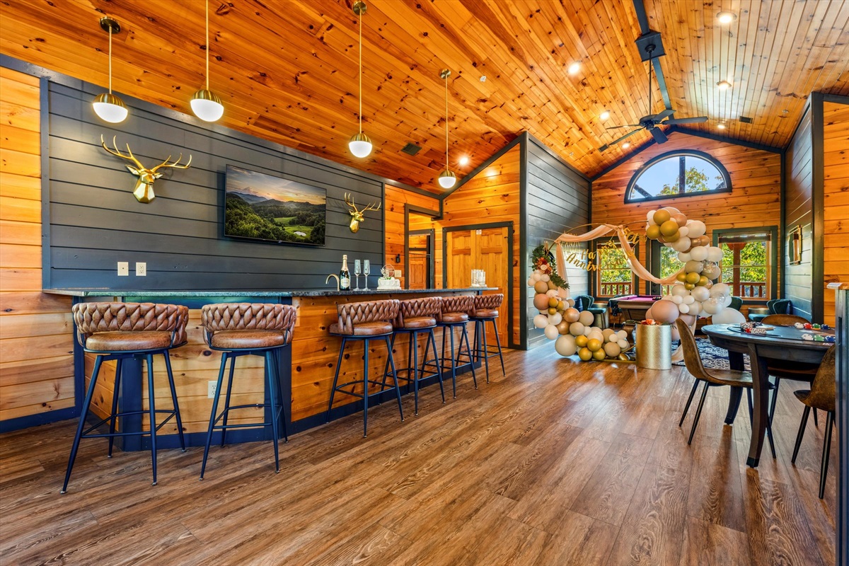 The upstairs bar/lounge has a bar, large Smart TV, poker table, foosball table, shuffleboard table, golf video game, and pool table!