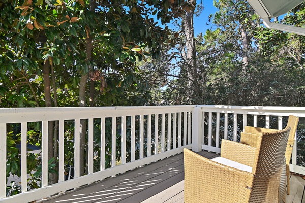 Cozy Coastal Chic Master Bedroom: Unwind in the master bedroom with a luxurious king-sized bed, private bath, and a balcony offering serene views.