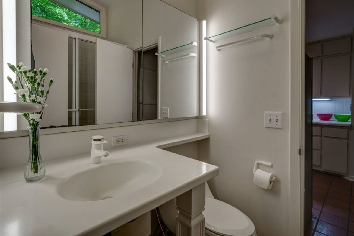 The master bathroom has another door leading into the kitchen. Walk-in shower. 