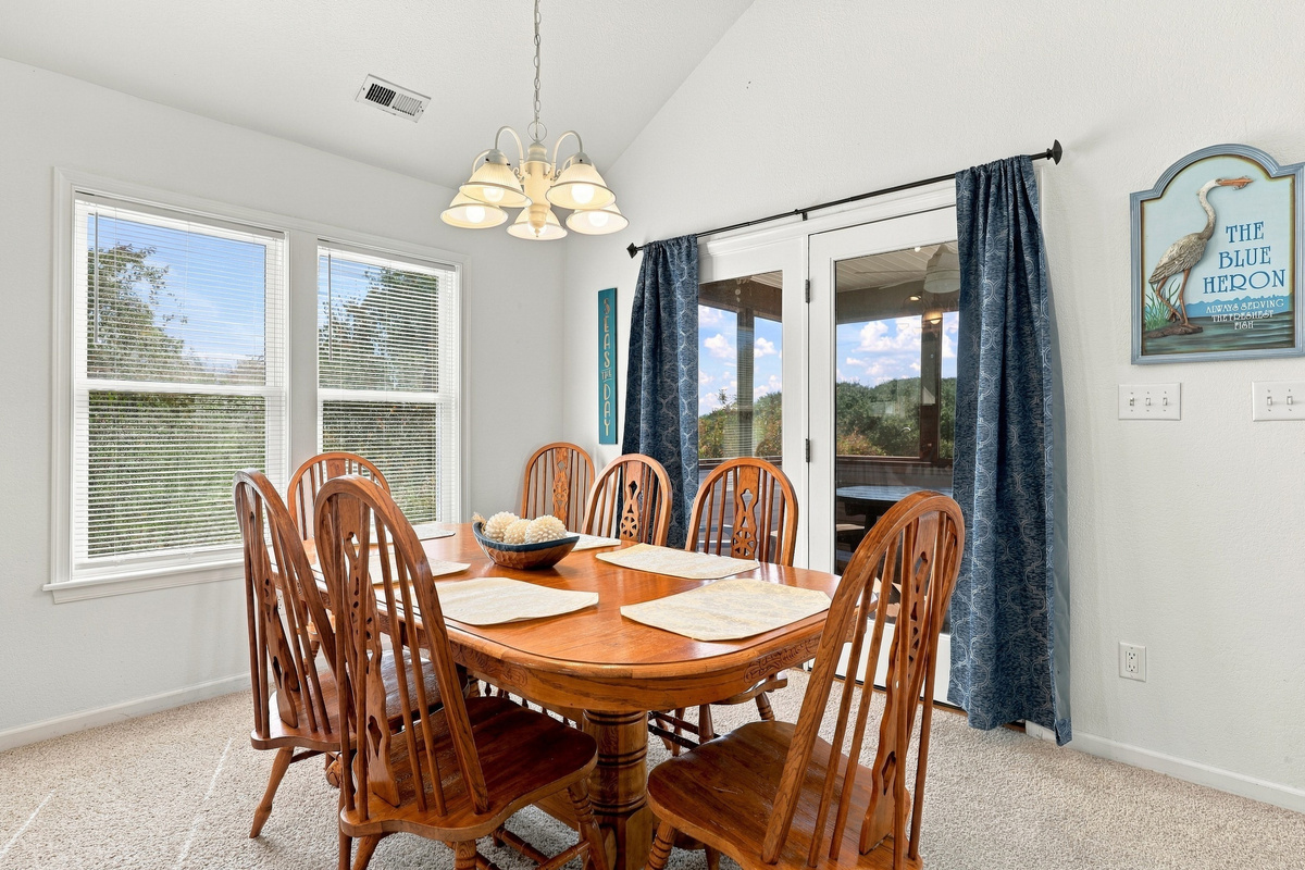 Open-concept living: kitchen, dining and living room flow together under vaulted ceilings.