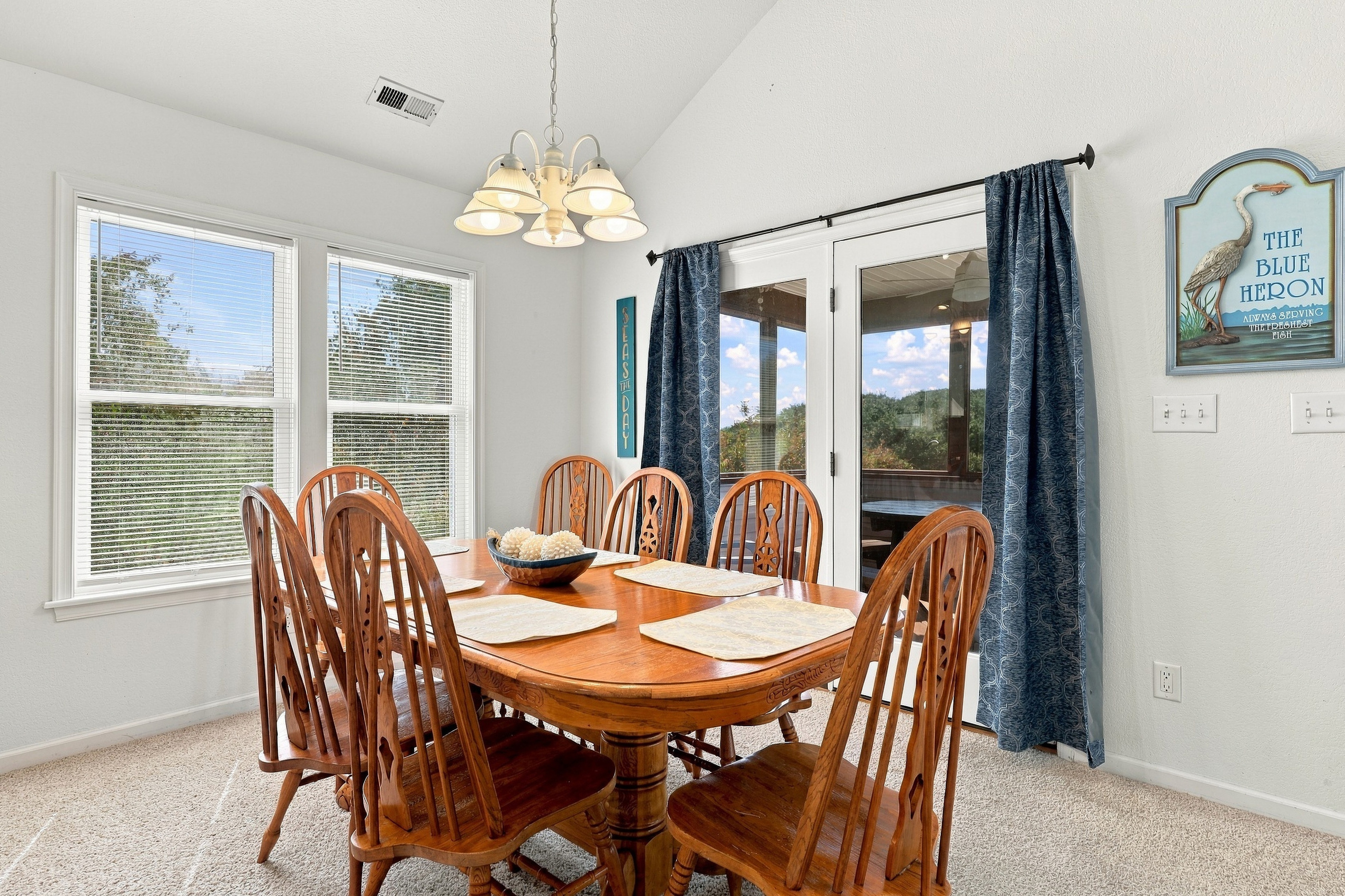 Open-concept living: kitchen, dining and living room flow together under vaulted ceilings.
