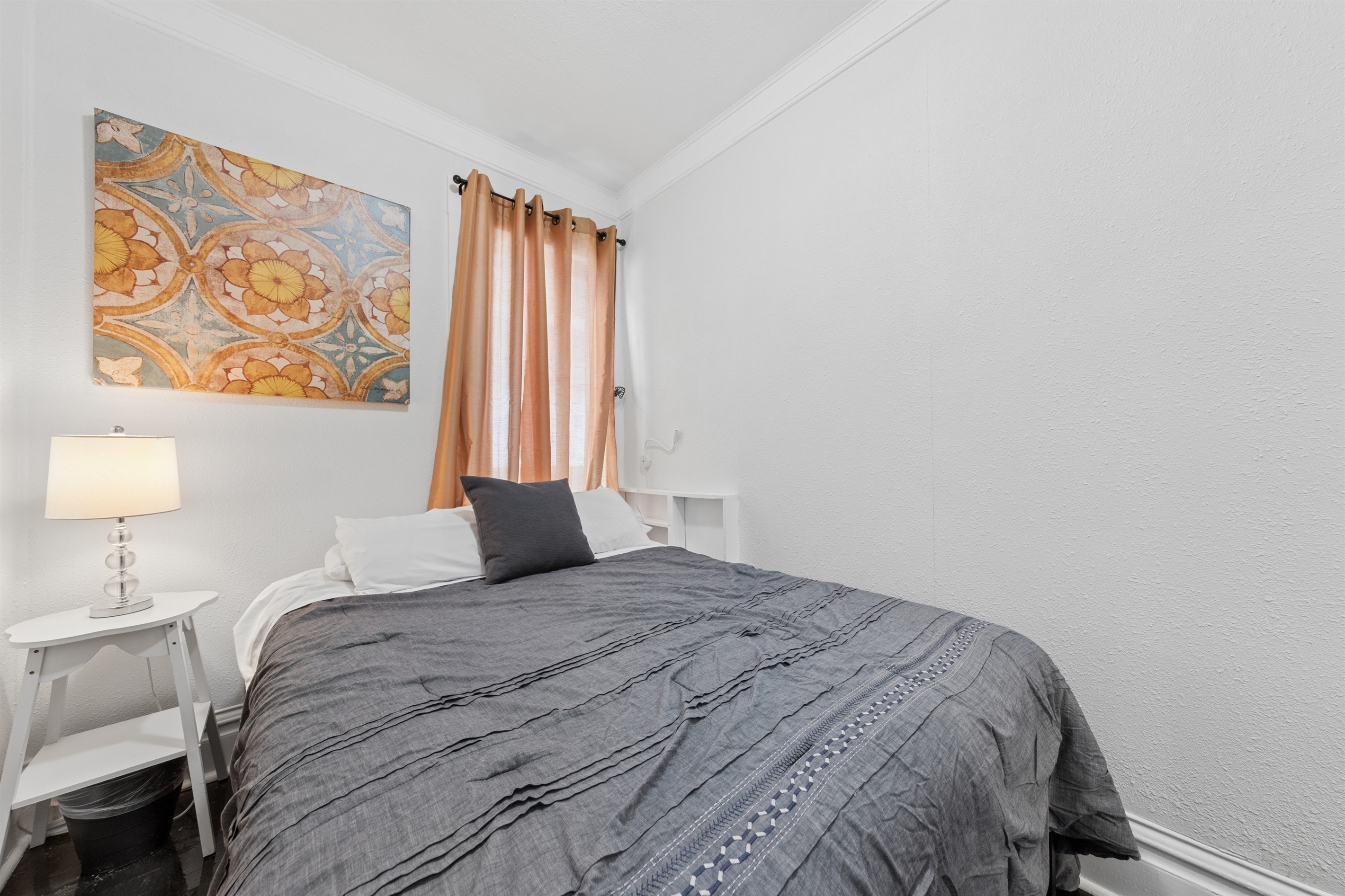 Enjoy the reading lamps and quiet comfort of this queen bedroom.