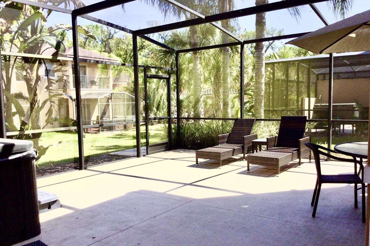 Private, covered lanai with lounge area, hot tub and dining area