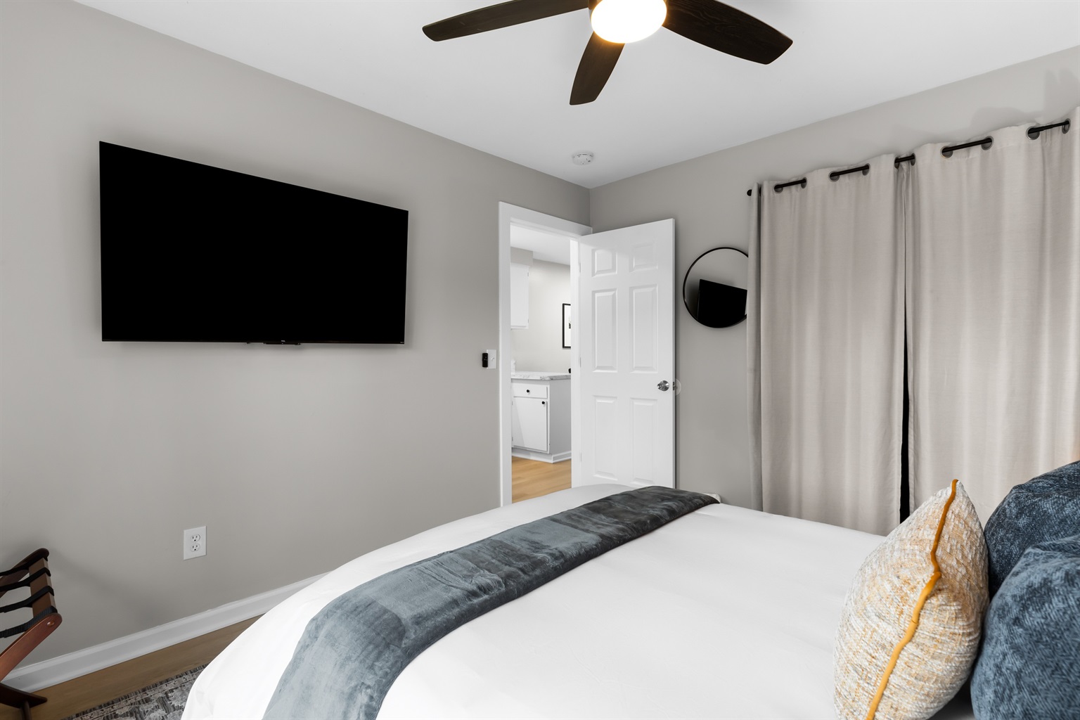 A stylish bedroom with a modern TV and dresser.