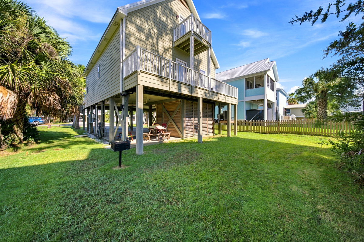 A spacious yard and peaceful, residential setting greet you in the daylight — plenty of room to unload and relax.