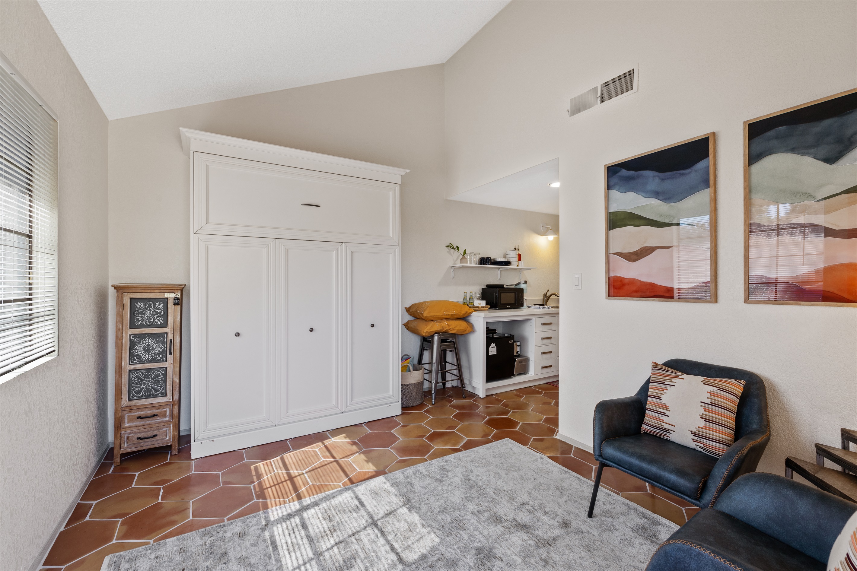 The studio bedroom with the Murphy bed in the closed/up position.