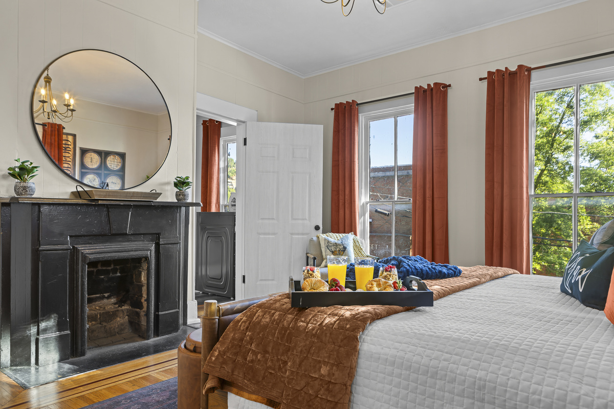 A vintage black fireplace and elegant gilt mirror anchor the Woodford Reserve Room, creating a warm and inviting setting for slow, cozy mornings.