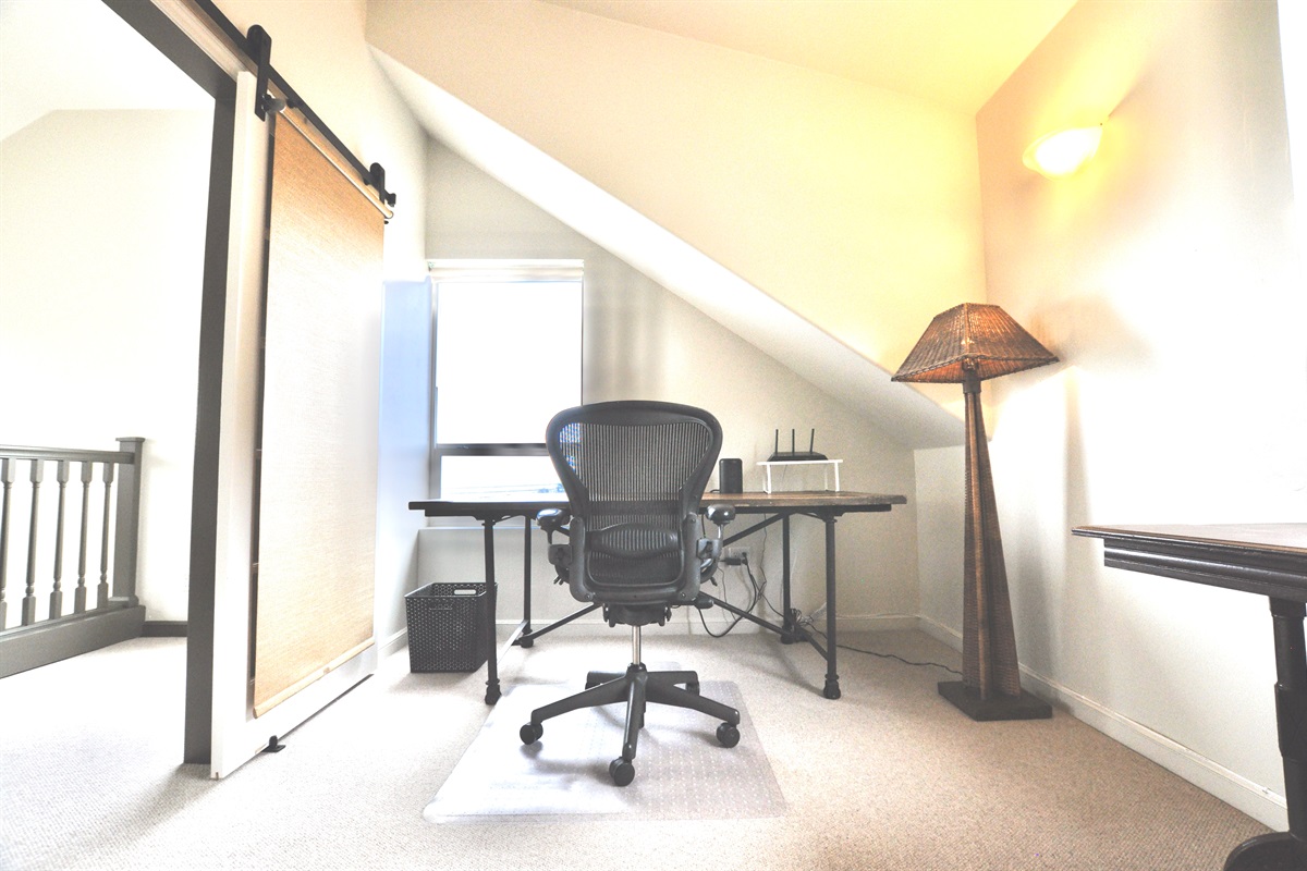 Full desk, office chair and monitor in the office/bedroom, with ocean views