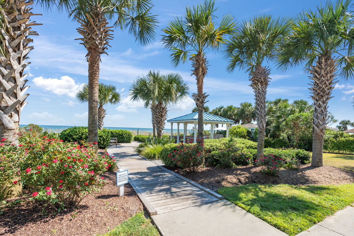 Landscaped resort grounds with palm trees and gazebo