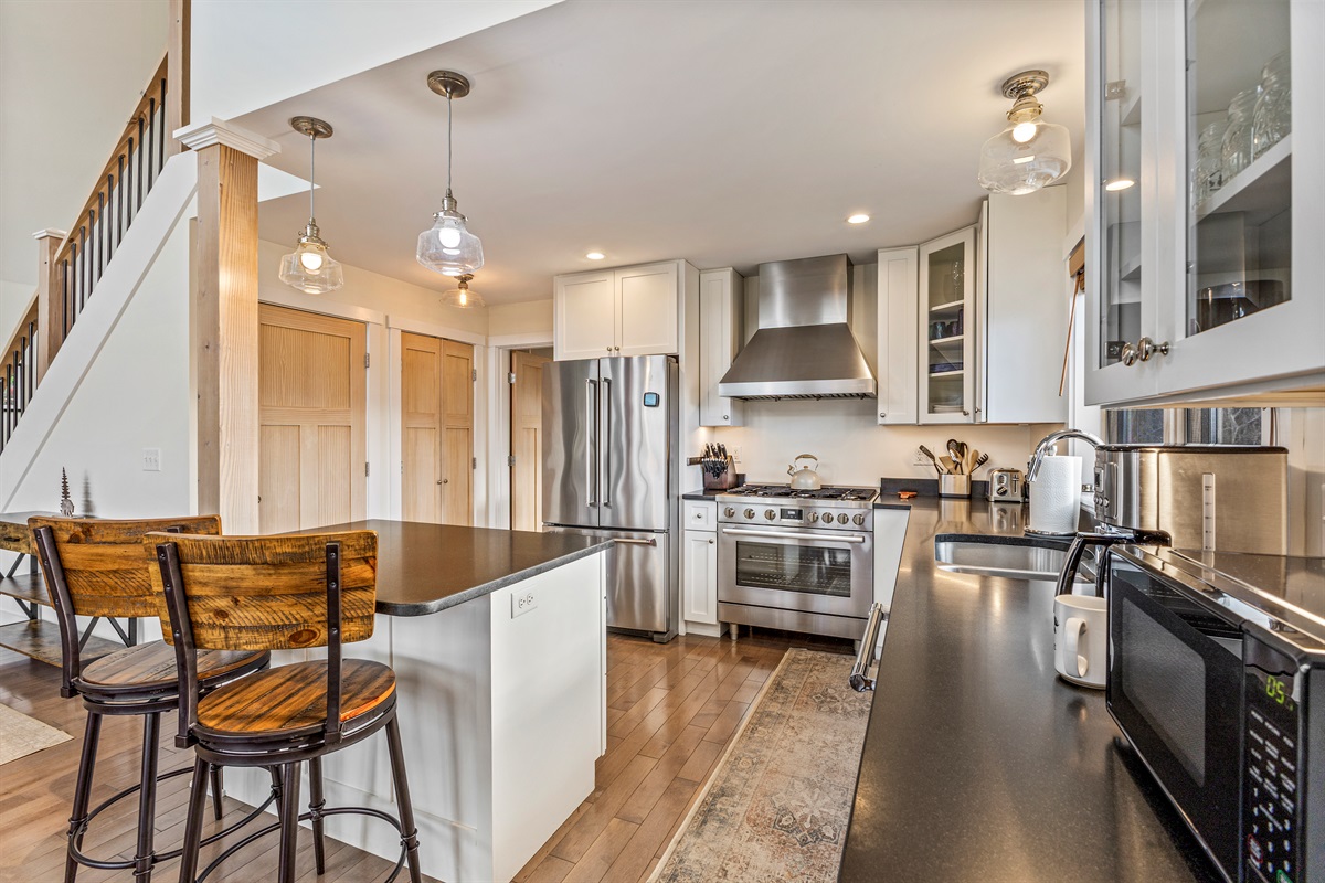 Prepare meals with ease in the modern kitchen, featuring an island with extra seating for friends and family.