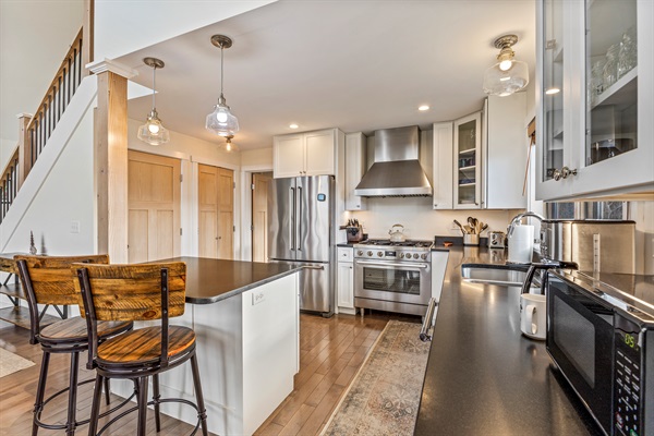 Prepare meals with ease in the modern kitchen, featuring an island with extra seating for friends and family.