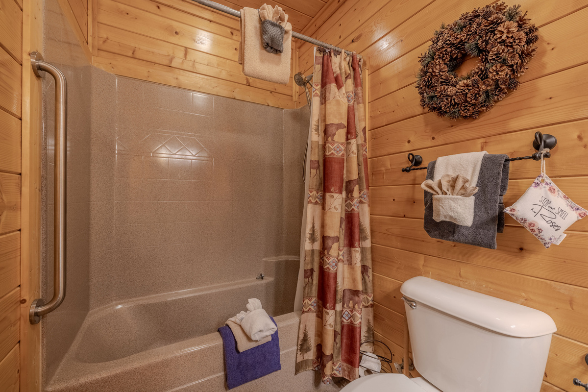 Main level bathroom has a tub / shower combination