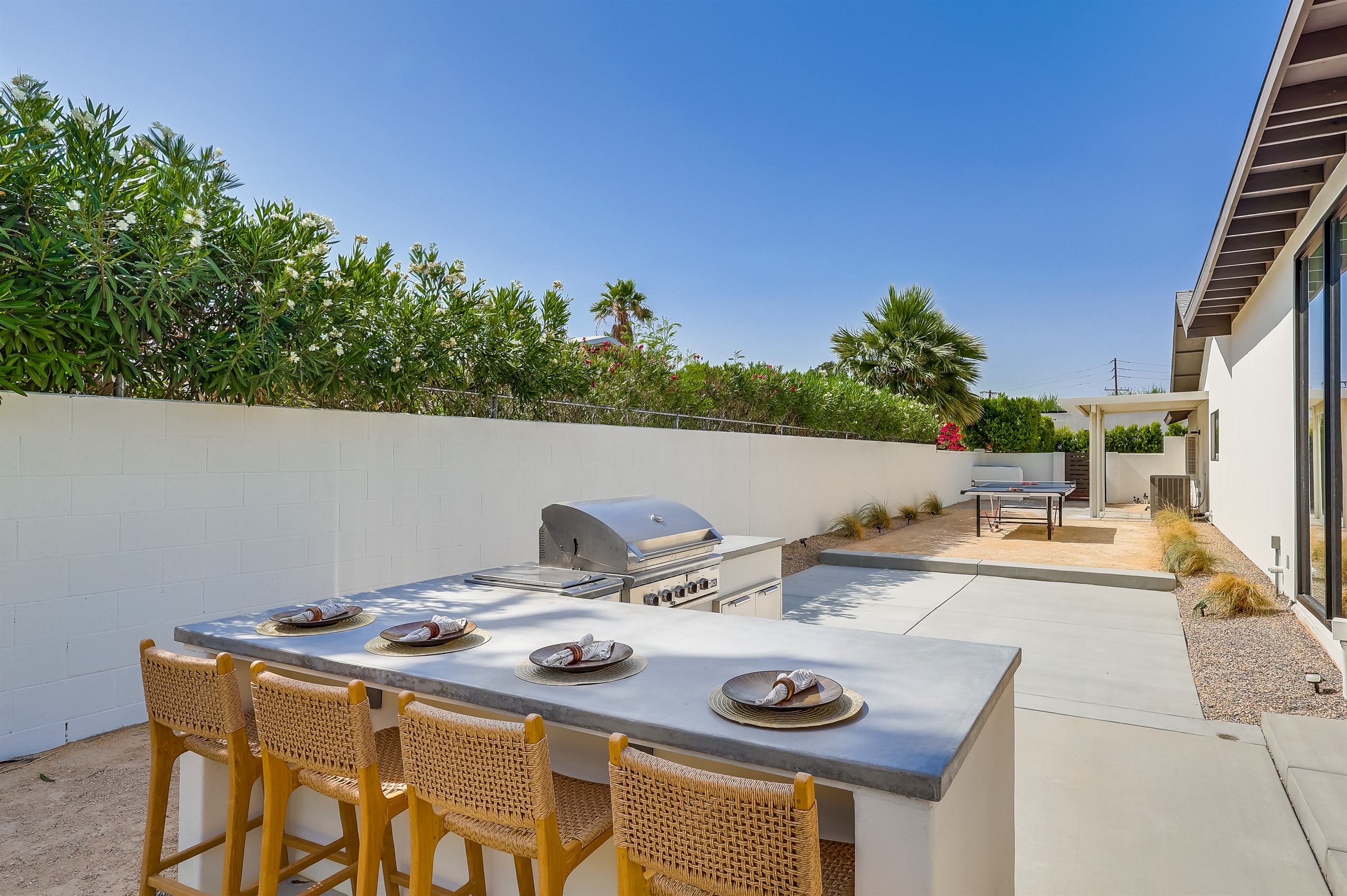 Outdoor BBQ grill with side burner, outdoor refrigerator and bar seating