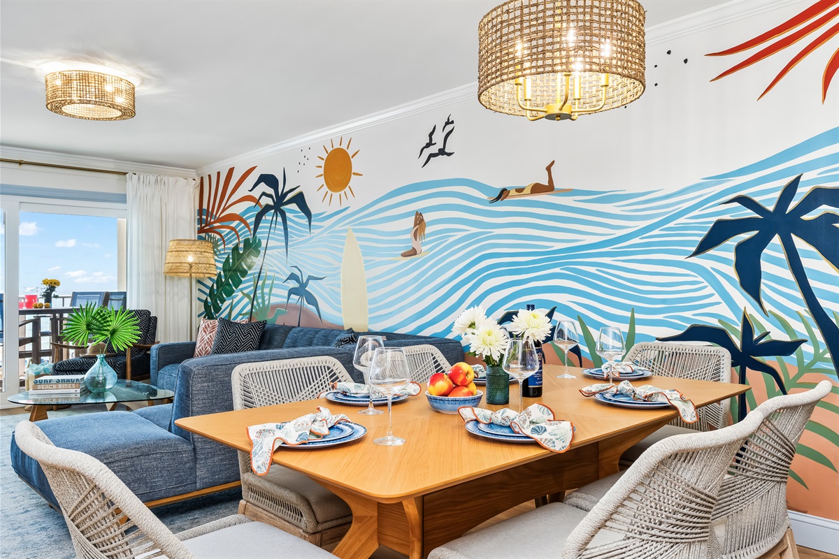 Open-concept living and dining space, placed in front of our hand-painted mural.