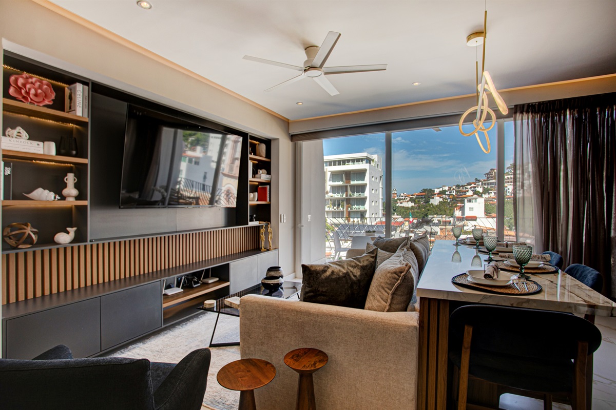 Enjoy a chic, modern living area featuring a comfortable sleeper sofa and stunning mountain views just beyond your door.