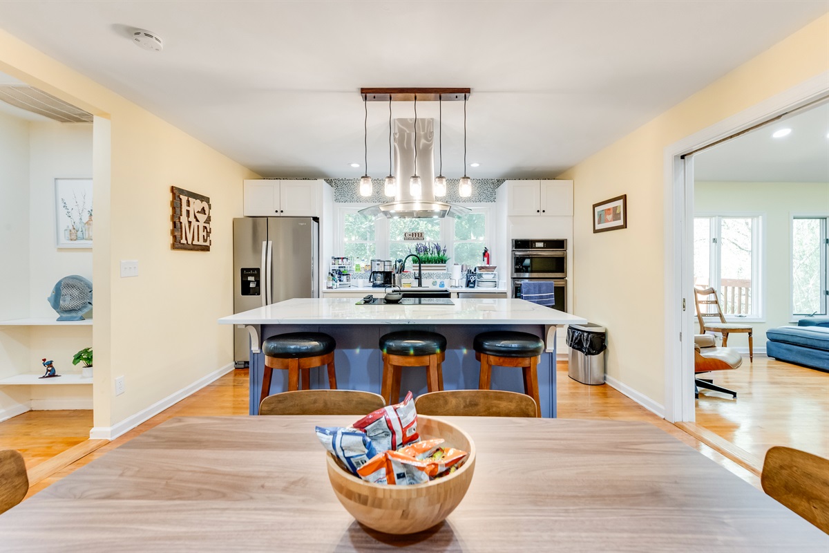 Kitchen: Modern design meets charm with a spacious island and inviting dining area!