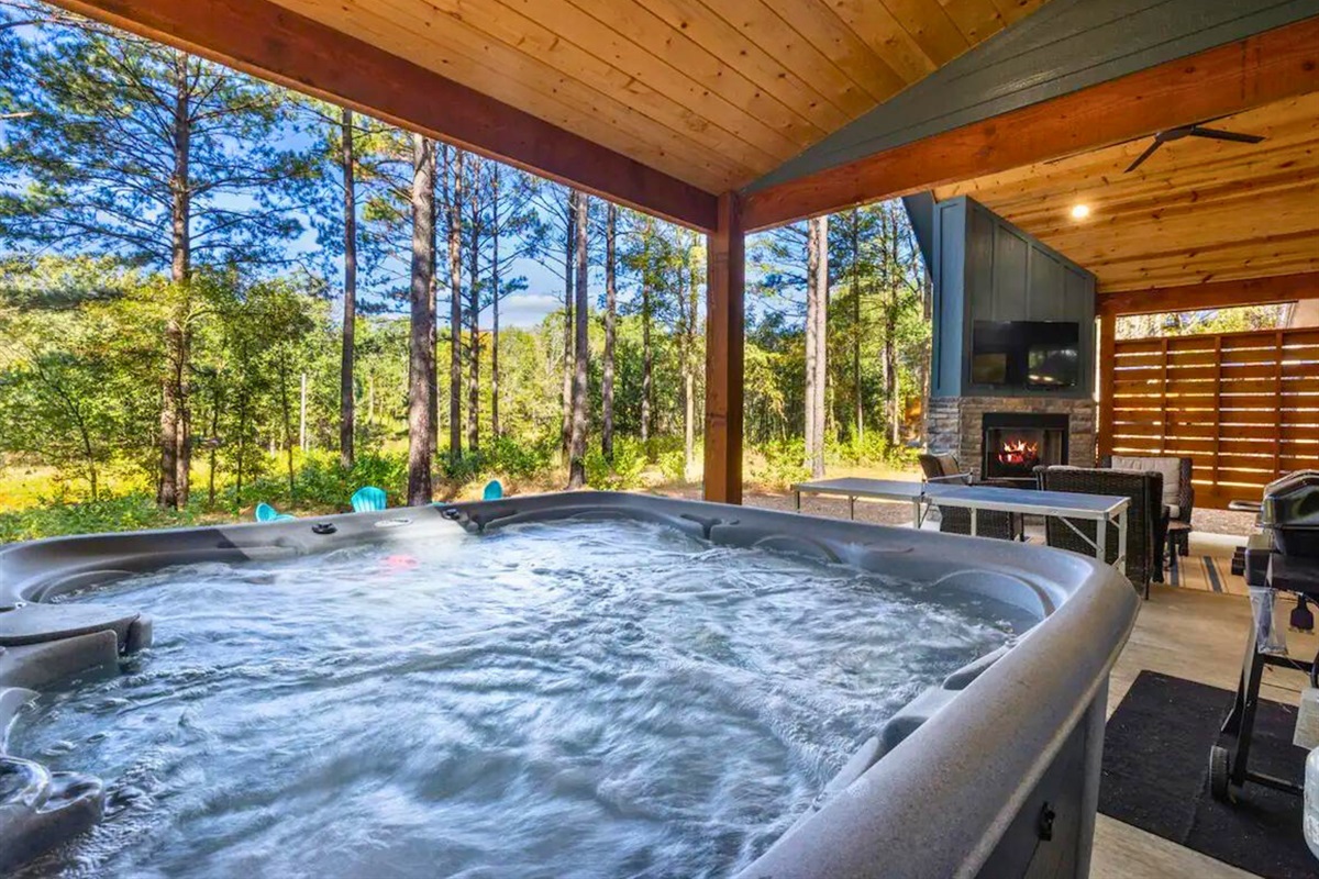 Relax in the warm embrace of the hot tub, with nature as your audience