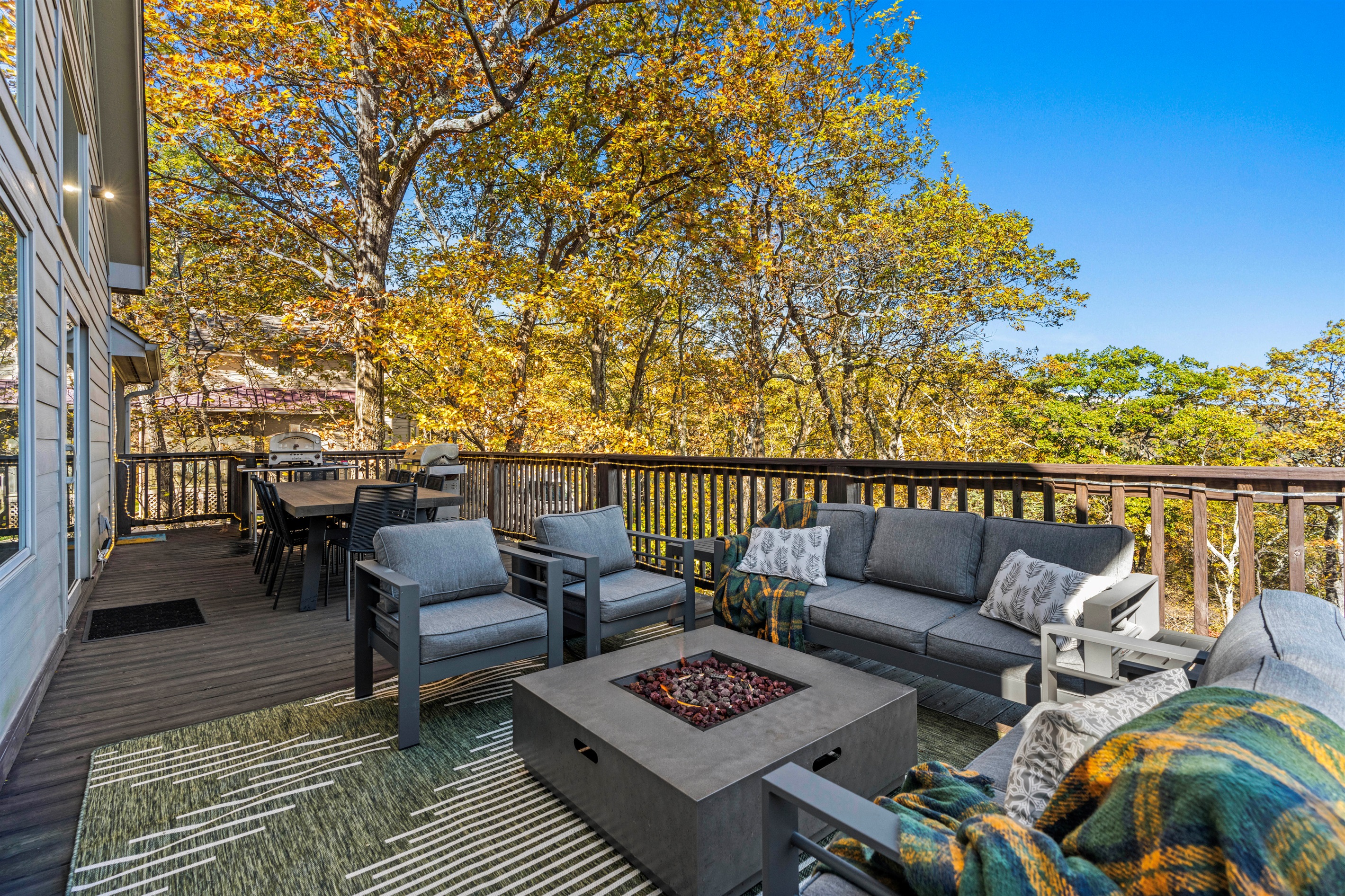 Crisp fall color wraps the main deck—gather for coffee or conversation amid golden trees and clear mountain air at Chateau Greenstone.