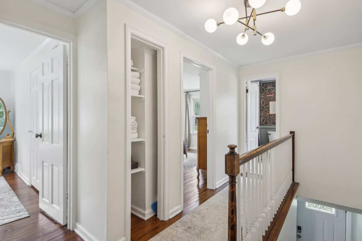 Move easily between the bedrooms and the bathroom from this bright upstairs hallway, which features convenient linen storage.