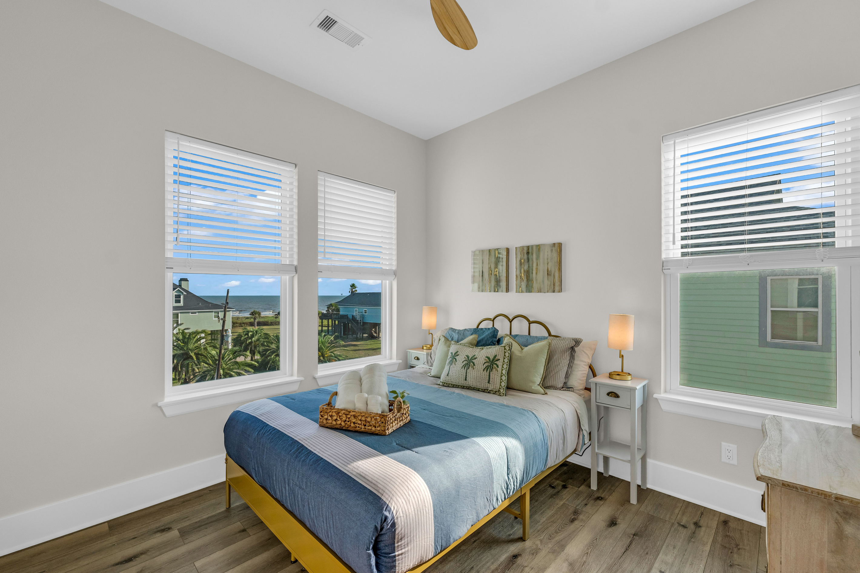Costa Cristal Bedroom 2: Cozy queen bed with large windows, natural light, and relaxing views. Perfect for a restful night’s sleep.