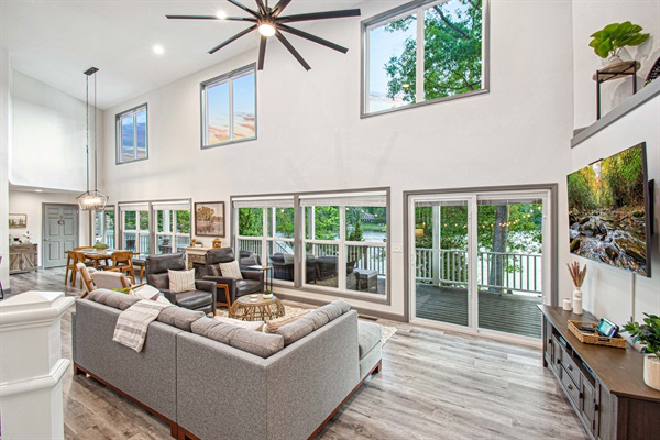 Immerse yourself in the stunning scenery of Lake Malone from the open living room, featuring large windows with sweeping views.