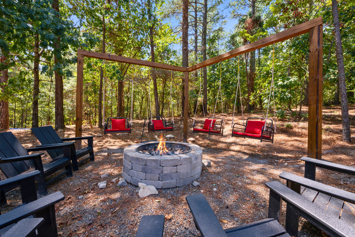 Gather around the fire pit beneath the towering pines, where plenty of seating makes it easy for the whole group to spend time together outdoors.
