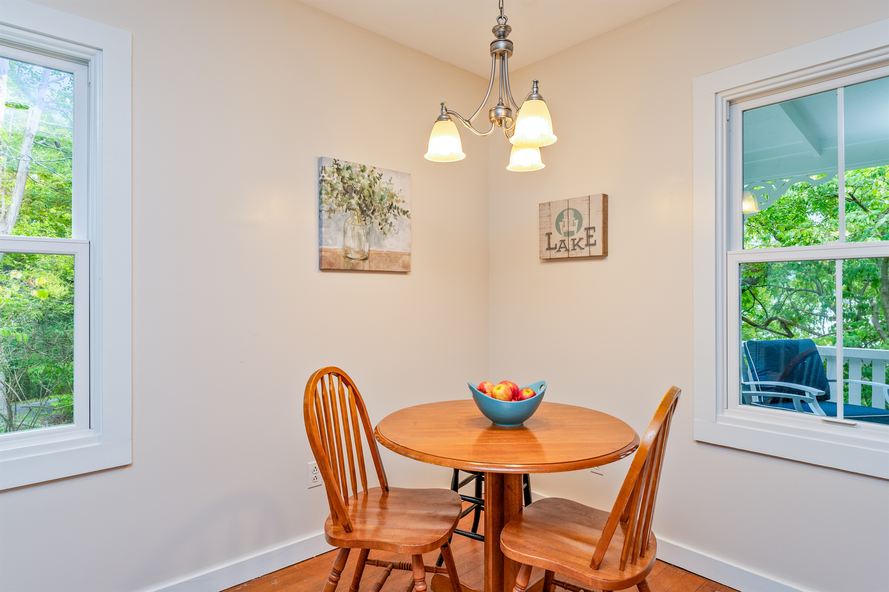 Charming dining corner with natural light and a warm wooden table set for two—an inviting spot to start your day.