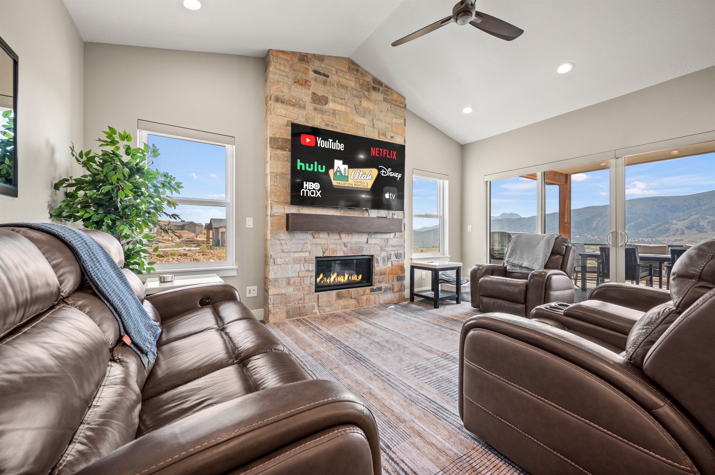 Spacious living room with Smart TV, gas fireplace, and stunning mountain views.