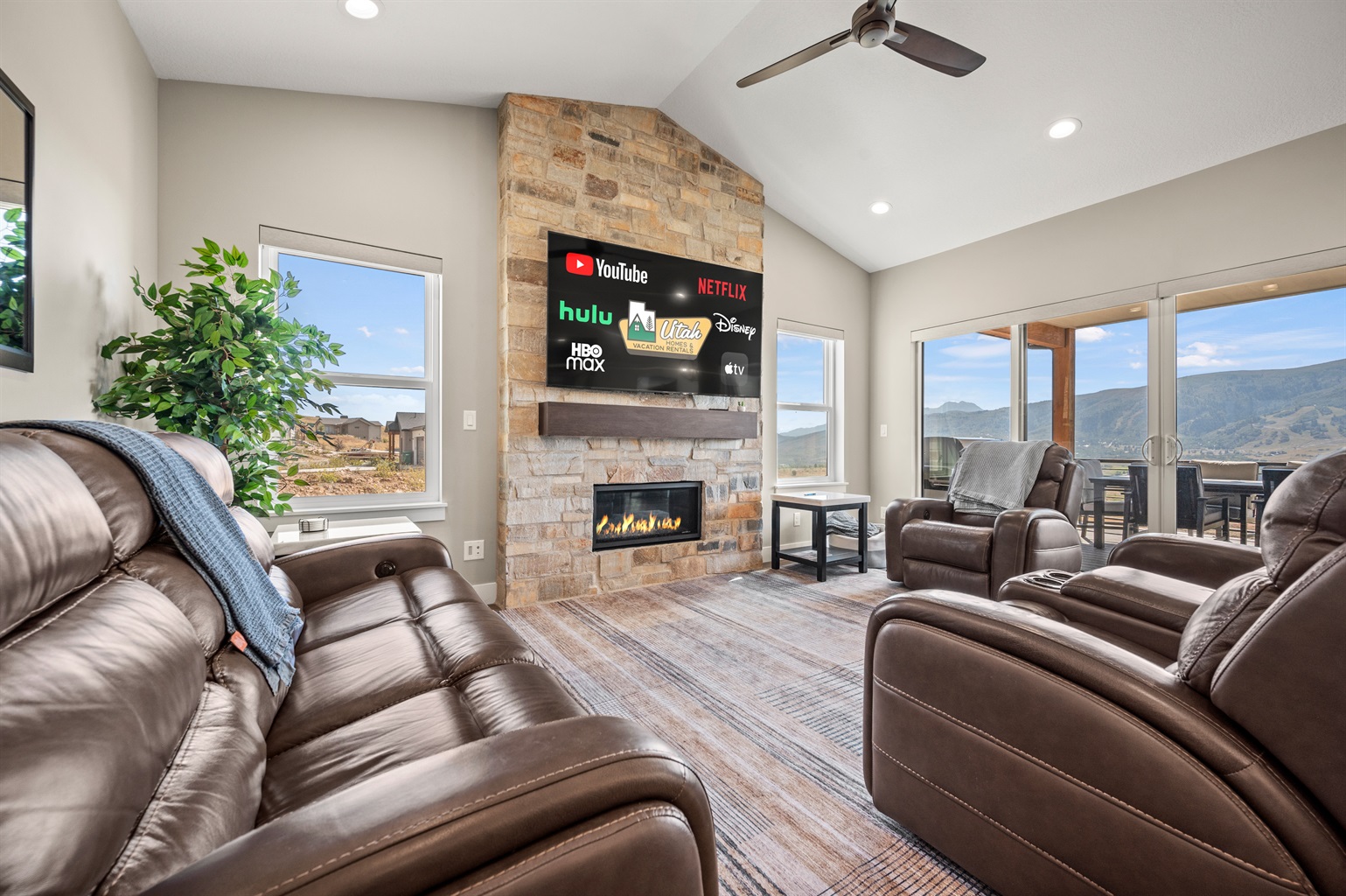 Spacious living room with Smart TV, gas fireplace, and stunning mountain views.