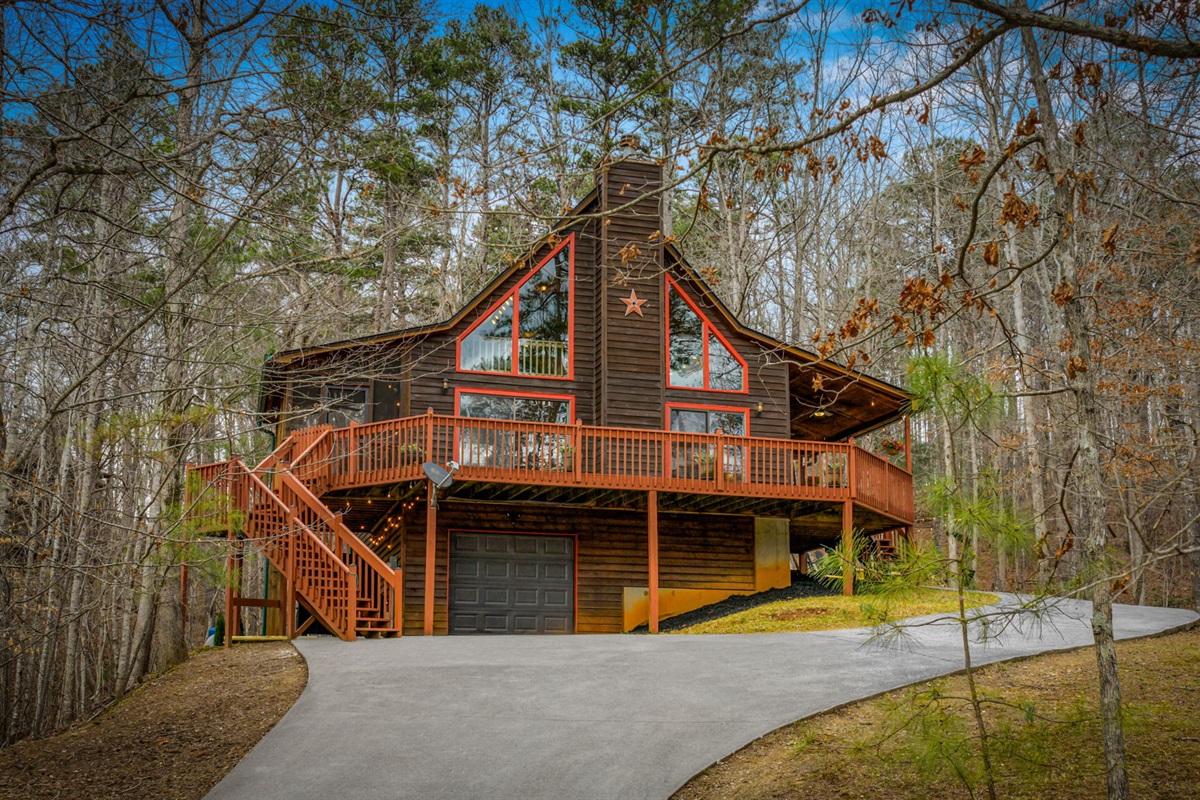 The front exterior of the home showcases a charming design with a well-balanced layout that blends beautifully with its natural surroundings.