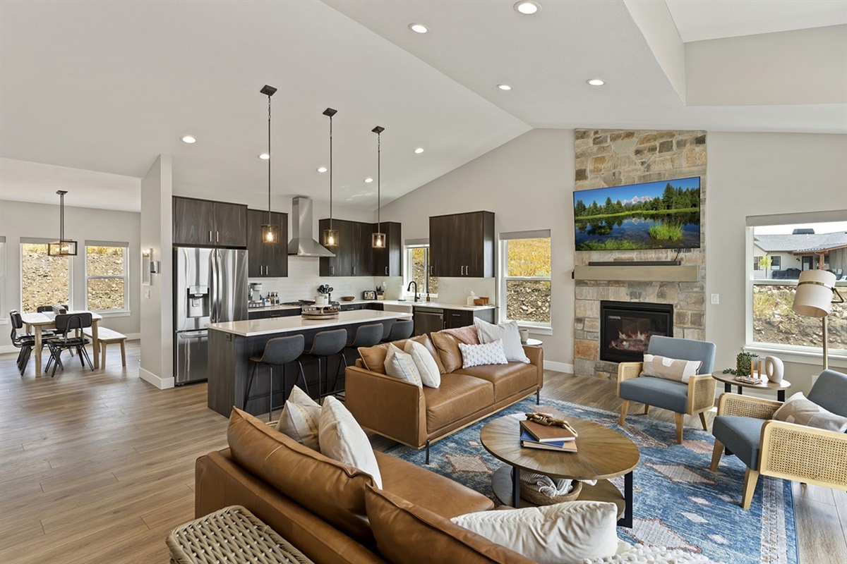 Open-concept great room with spacious seating, fireplace, and upscale finishes