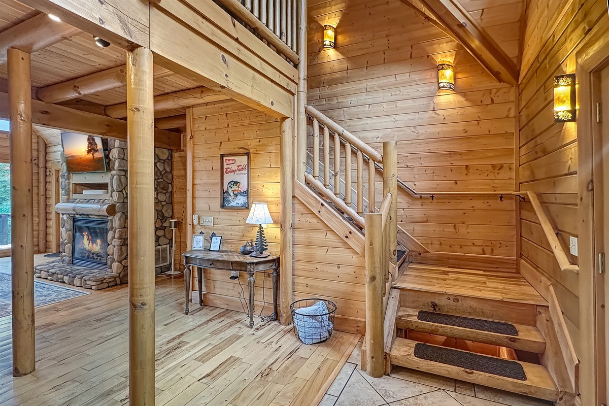 Entryway: Step into rustic charm with warm wood accents and a cozy fireplace ambiance!