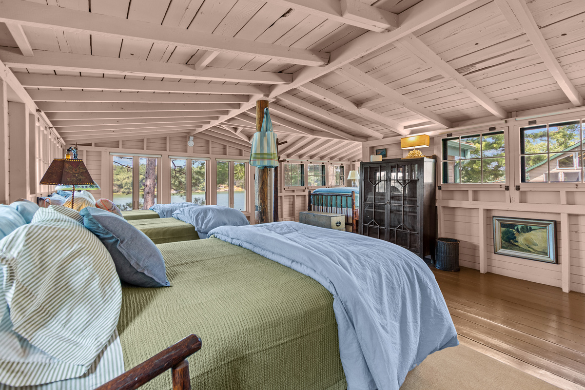 Upstairs, the summer camp feeling continues with plenty of room to spread out, charming cottage character, and beautiful lake views right outside the windows.