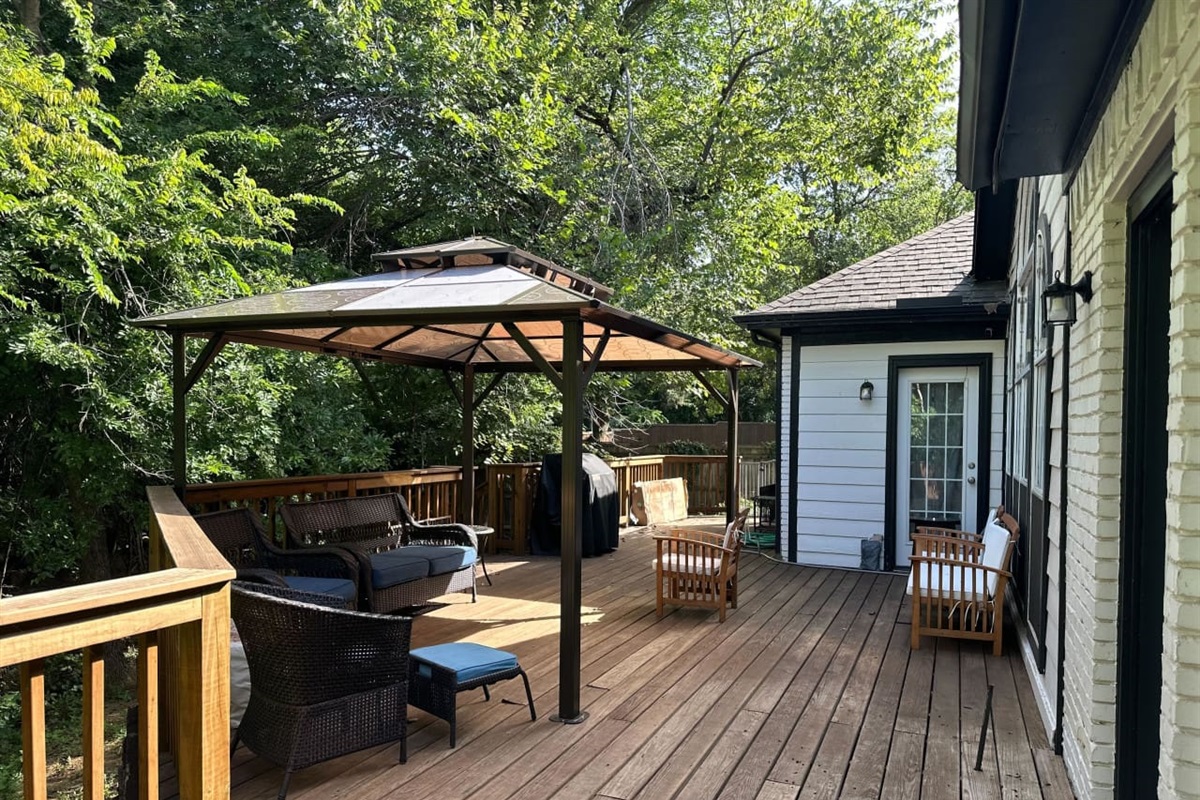 Back patio with BBQ gas grill and lots of shaded seating.