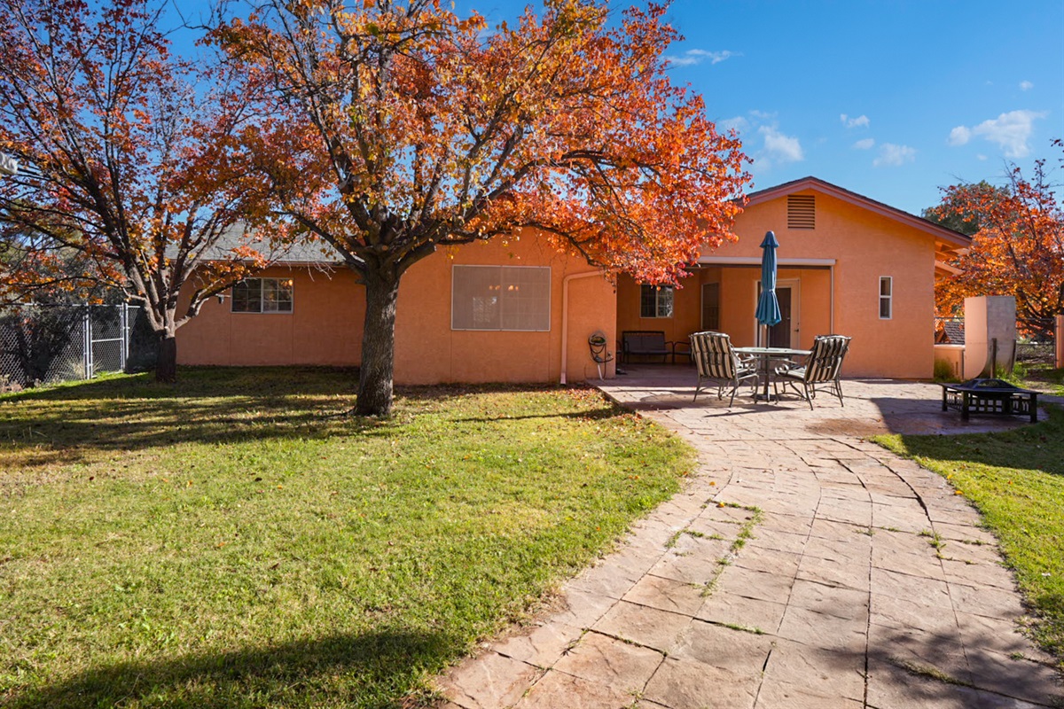 Spacious grassy yard with patio seating—great for kids, pets, and outdoor play.