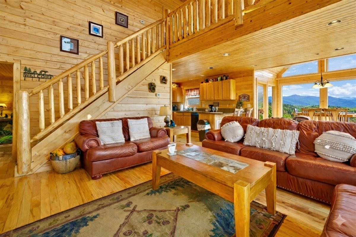 Step into this spacious living room where mornings begin with soft sunlight streaming through the windows and evenings end with laughter by the fire. It’s the heart of the cabin a place to gather, relax, and make memories that linger long after your stay.
