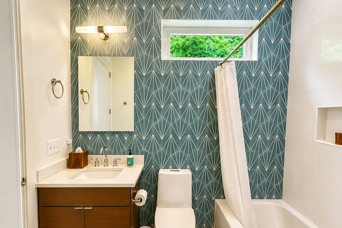 Convenient and stylish.
This full bathroom is located on the main level with access from both the foyer and the queen guest bedroom, making it easy and comfortable for guests to settle in.
