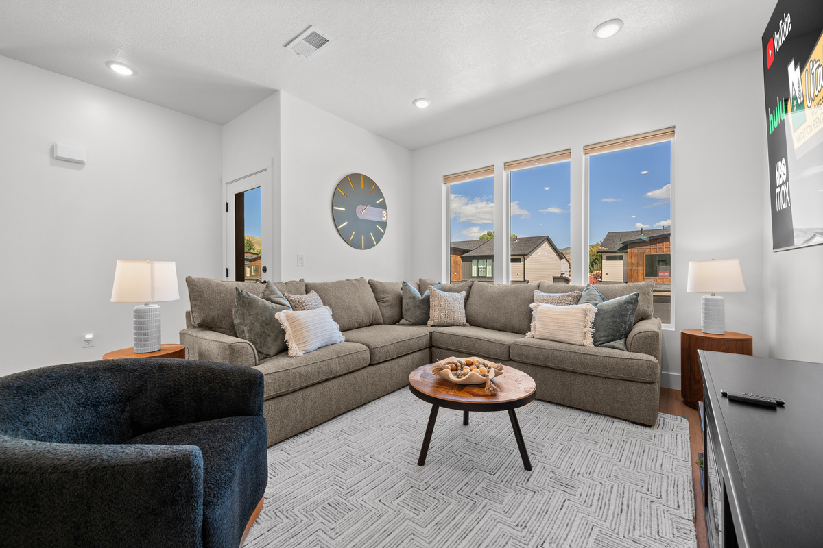Bright and comfortable, the living room provides a relaxing place to settle in with plenty of seating for everyone.