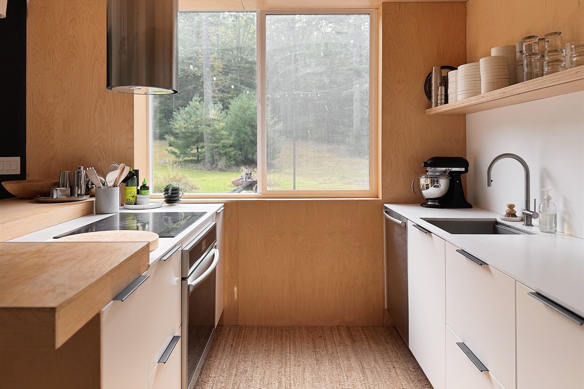 Open kitchen with sliding window overlooking the field.