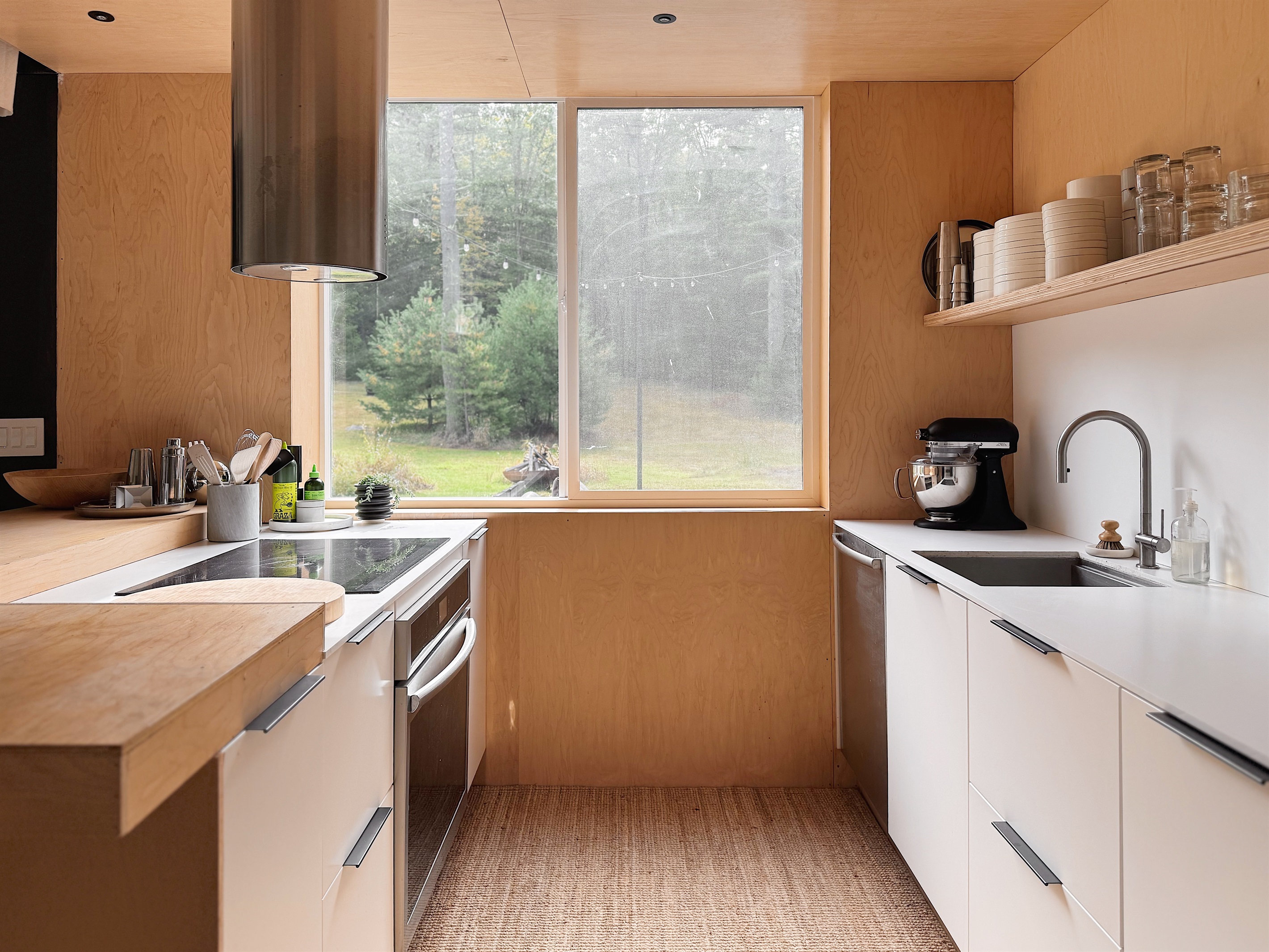 Open kitchen with sliding window overlooking the field.