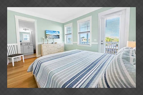 Master bedroom with a private balcony and water views.