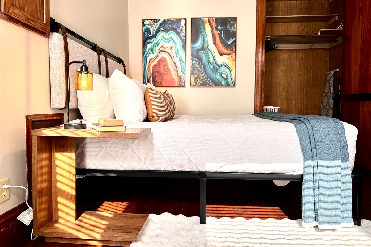 Dimming bedside lamps with usb ports, quality linens and blankets, and a cozy faux rabbit rug will have you feeling relaxed in no time!