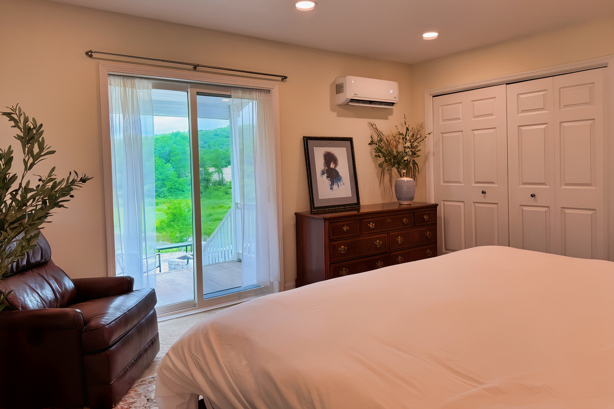 Lower level King Bedroom with sliding glass doors to a private sitting porch