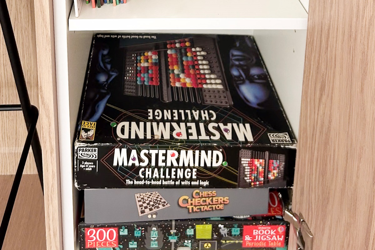 The games cupboard adds simple indoor entertainment, with board games and kids’ books stored neatly beside the living spaces.