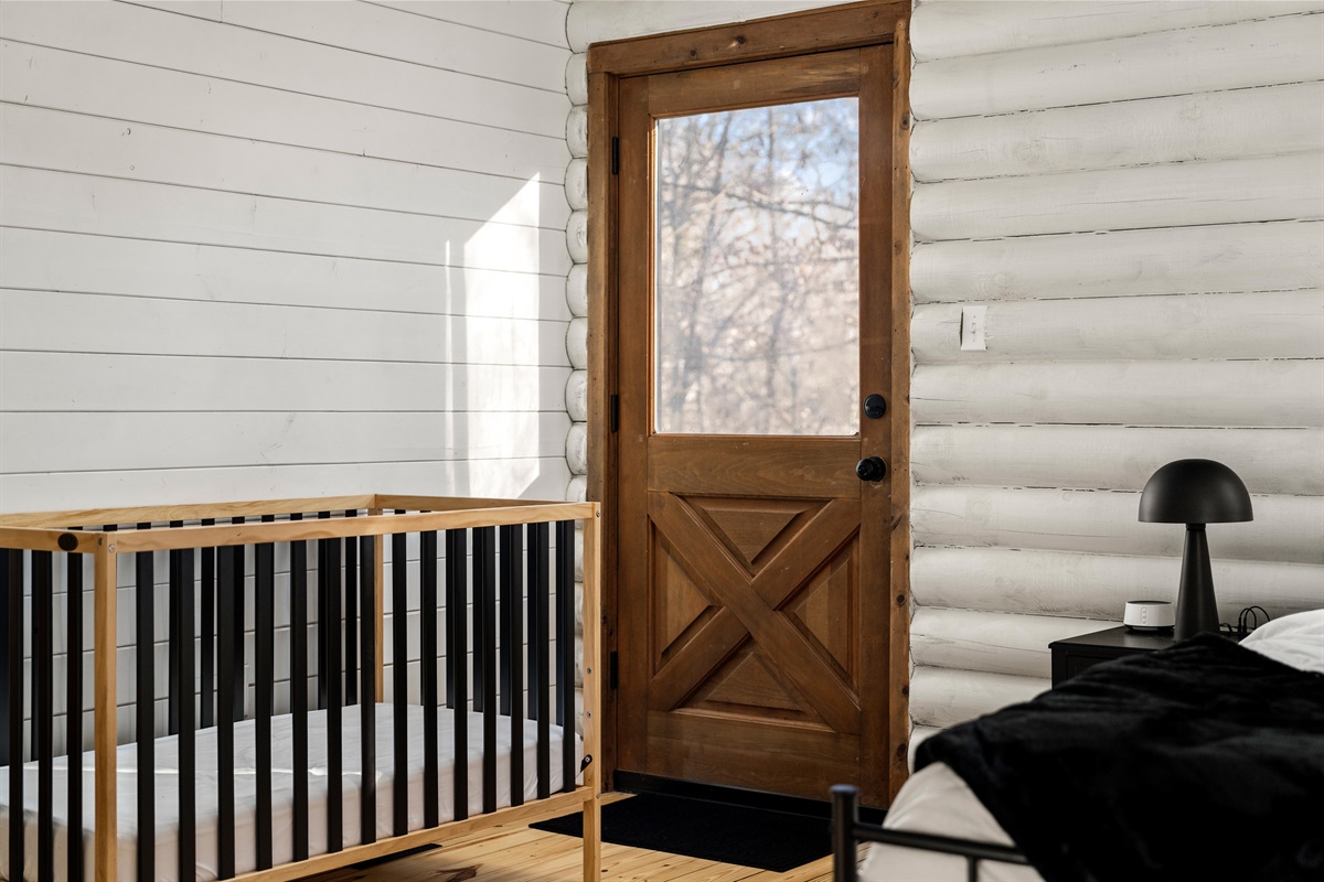 Bedroom 2: Bright and airy space with a playful crib, ideal for your little one's dreams!