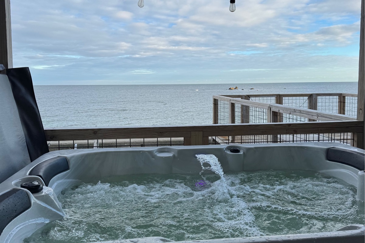 Relax in the private hot tub, perfect for unwinding after a beach day or enjoying a peaceful evening under the stars.