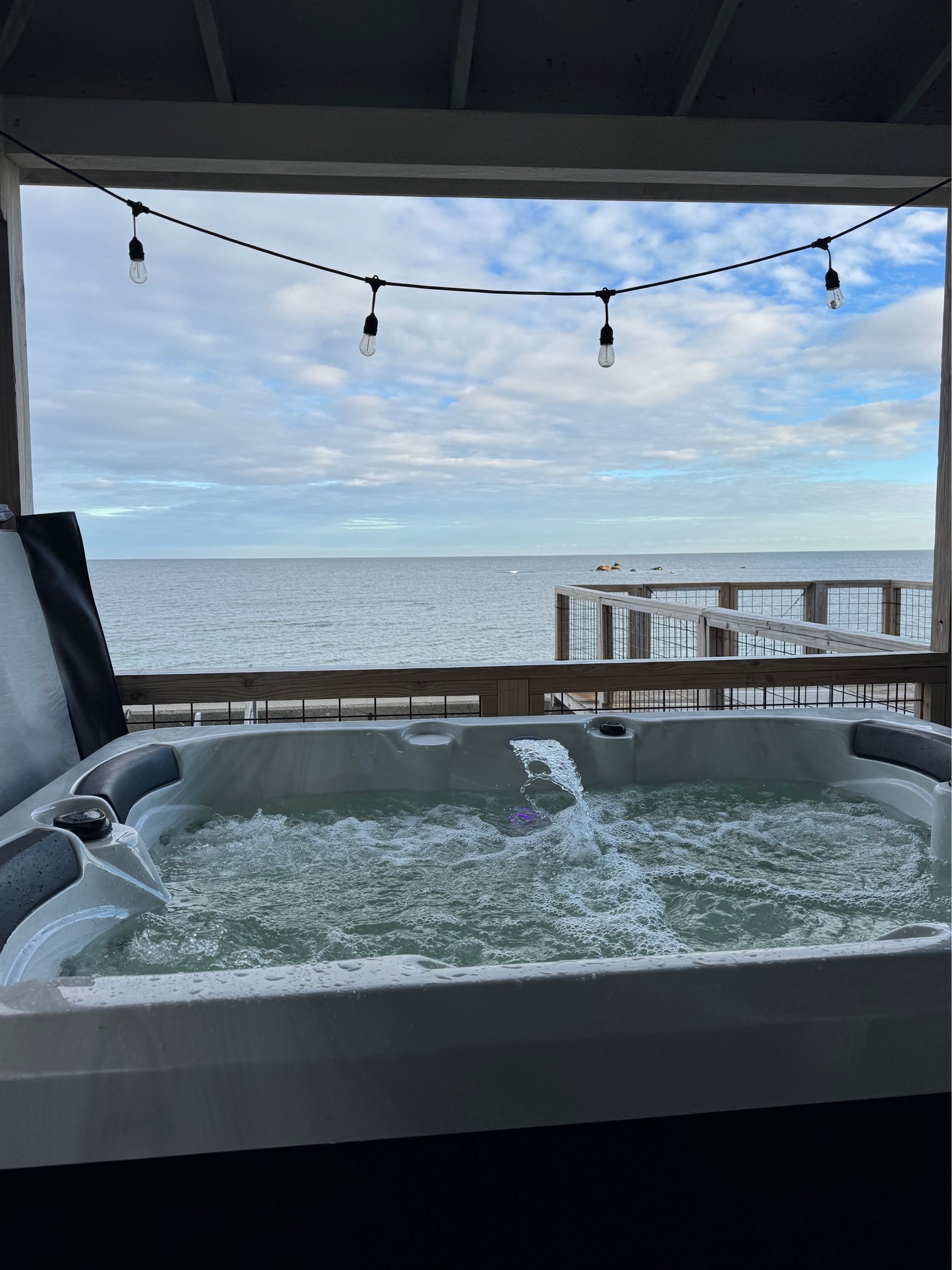 Relax in the private hot tub, perfect for unwinding after a beach day or enjoying a peaceful evening under the stars.