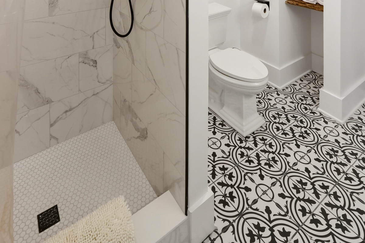 Large, newly remodeled bathroom with double vanity and tile shower.